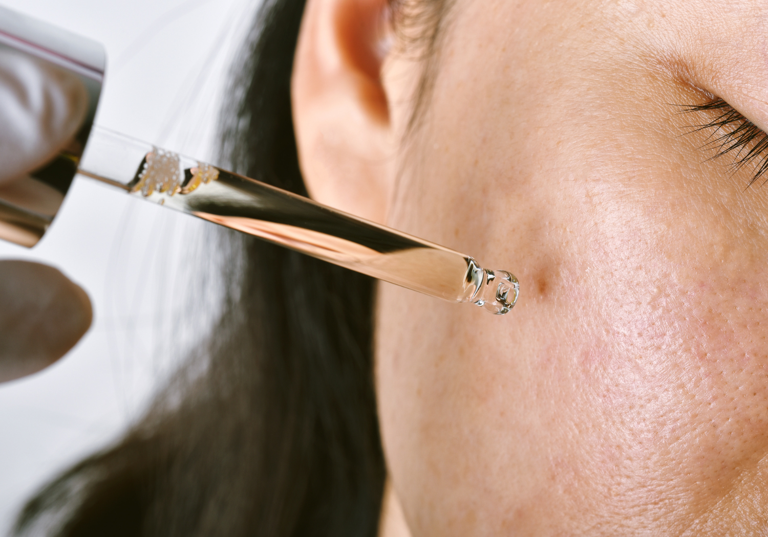 Woman using Rawah's serum on her face 