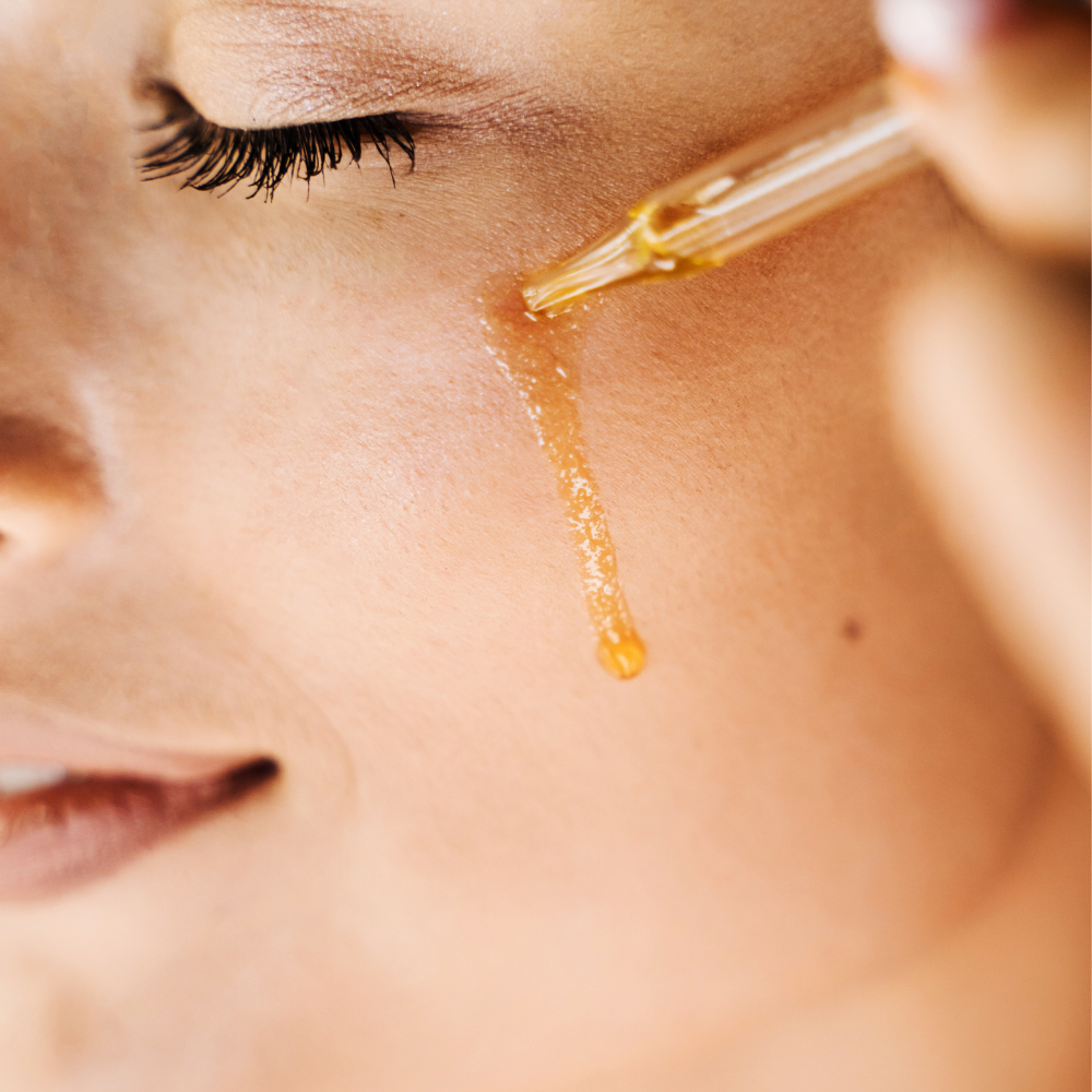 Woman applying Vitamin c serum of rawah on her face